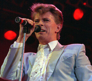 Rock star David Bowie performs on stage at Wembley Stadium, London, July 13, 1985, during the Live Aid famine relief rock concert. (AP Photo/Joe Schaber)